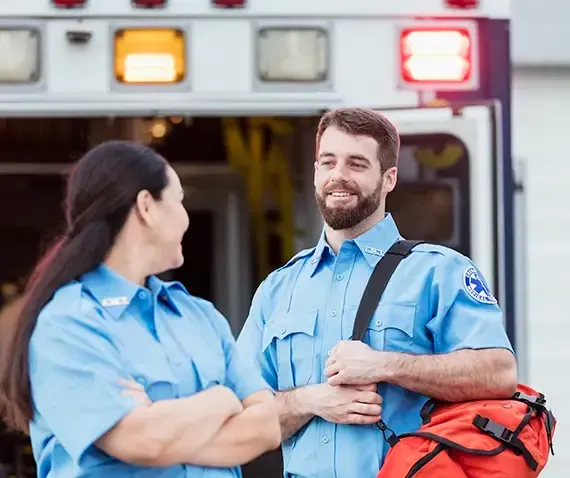First responder professionals discussing near an ambulance
